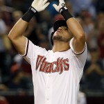 Arizona Diamondbacks' David Peralta points to the sky as he arrives at home plate after hitting a grand slam against the Philadelphia Phillies during the second inning of a baseball game Tuesday, Aug. 11, 2015, in Phoenix. (AP Photo/Ross D. Franklin)
