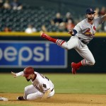 St. Louis Cardinals second baseman Greg Garciaright, right, turns the double play while avoiding Arizona Diamondbacks Ender Inciarte on a ball hit by Jake Lamb during the eighth inning during a baseball game, Tuesday, Aug. 25, 2015, in Phoenix. The Cardinals won 9-1. (AP Photo/Rick Scuteri)