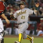Oakland Athletics' Stephen Vogt scores on a base hit by Marcus Semien in the eleventh inning during a baseball game against the Arizona Diamondbacks, Sunday, Aug. 30, 2015, in Phoenix. (AP Photo/Rick Scuteri)