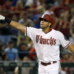 Arizona Diamondbacks' David Peralta points to the crowd as he rounds the bases after hitting a grand slam against the Philadelphia Phillies during the second inning of a baseball game Tuesday, Aug. 11, 2015, in Phoenix. (AP Photo/Ross D. Franklin)