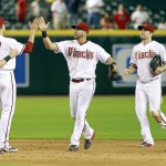 Arizona Diamondbacks' David Peralta, center, and A.J. Pollock, right, are congratulated by teammates Chris Owings, left, and Nick Ahmend following a 13-3 victory against the Philadelphia Phillies during a baseball game, Monday, Aug. 10, 2015, in Phoenix. (AP Photo/Ralph Freso)