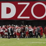 Arizona Cardinals players and staff meet on the field at University of Phoenix Stadium at the end of NFL football training camp Thursday, Aug. 13, 2015, in Glendale, Ariz. (AP Photo/Ross D. Franklin)