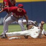 Atlanta Braves' Jace Peterson is tagged out by Arizona Diamondbacks shortstop Nick Ahmed (13) as he tries to steal second base in the second innings of a baseball game Sunday, Aug. 16, 2015, in Atlanta. (AP Photo/John Bazemore)