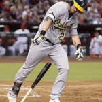 Oakland Athletics' Josh Reddick throws down his bat as he pops out to the infield during the third inning of a baseball game against the Arizona Diamondbacks, Friday, Aug. 28, 2015, in Phoenix. (AP Photo/Ross D. Franklin)