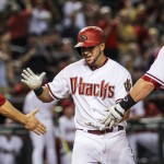 Arizona Diamondbacks left fielder David Peralta (6) is congratulated by teammates after hitting a grand slam during the second inning of a baseball game against the Philadelphia Phillies on Tuesday, Aug. 11, 2015, in Phoenix. (Isaac Hale/The Arizona Republic via AP)