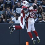 Arizona Cardinals defensive back Cariel Brooks, left, celebrates after scoring on an 81-yard interception return for a touchdown with defensive back Tony Jefferson (22) during the second half of an NFL preseason football game against the Oakland Raiders, Sunday, Aug. 30, 2015 in Oakland, Calif. (AP Photo/Tony Avelar)