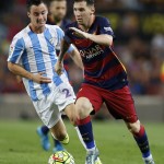 FC Barcelona's Lionel Messi, from Argentina, right, duels for the ball against Malaga's Raul Albentosa during a Spanish La Liga soccer match at the Camp Nou stadium in Barcelona, Spain, Saturday, Aug. 29, 2015. (AP Photo/Manu Fernandez)