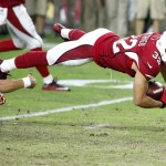 Arizona Cardinals free safety Tyrann Mathieu (32) is tripped up by Kansas City Chiefs quarterback Alex Smith (11) after intercepting a pass by Smith during the first half of an NFL preseason football game, Saturday, Aug. 15, 2015, in Glendale, Ariz. (AP Photo/Ross D. Franklin)