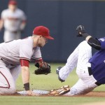 Arizona Diamondbacks shortstop Chris Owings, left, makes a late tag as Colorado Rockies' Charlie Blackmon steals second base in the first inning of a baseball game Monday, Aug. 31, 2015, in Denver. (AP Photo/David Zalubowski)