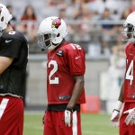 Arizona Cardinals wide receivers J.J. Nelson (14) and John Brown (12) arrive in the huddle behind quarterback Drew Stanton, left, during NFL football training camp Thursday, Aug. 13, 2015, in Glendale, Ariz.  The two receivers (AP Photo/Ross D. Franklin)