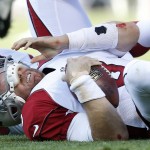 Arizona Cardinals quarterback Carson Palmer (3) rests on the ground after being sacked by Oakland Raiders outside linebacker Khalil Mack during the first half of an NFL preseason football game in Oakland, Calif., Sunday, Aug. 30, 2015. (AP Photo/Tony Avelar)