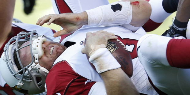 Arizona Cardinals quarterback Carson Palmer (3) rests on the ground after being sacked by Oakland R...