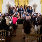 Guests photograph President Barack Obama as he speaks in the East Room of the White House in Washington, Wednesday, Aug. 26, 2015, during a ceremony honoring the WNBA basketball Champions Phoenix Mercury. (AP Photo/Andrew Harnik)