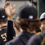 Pittsburgh Pirates' Aramis Ramirez, right, is greeted in the dugout after scoring with Jung Ho Kang on a hit by Pedro Alvarez in the fifth inning of a baseball game against the Arizona Diamondbacks, Tuesday, Aug. 18, 2015, in Pittsburgh. (AP Photo/Keith Srakocic)