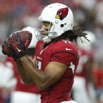 Arizona Cardinals wide receiver Larry Fitzgerald warms up for the team's NFL preseason football game against the Kansas City Chiefs, Saturday, Aug. 15, 2015, in Glendale, Ariz. (AP Photo/Rick Scuteri)