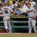 Arizona Diamondbacks' Chris Owings, left,  is greeted by on-deck batter Ender Inciarte, right,  after scoring on a single by Jeremy Hellickson in the second inning of a baseball game, Monday, Aug. 17, 2015, in Pittsburgh. (AP Photo/Keith Srakocic)