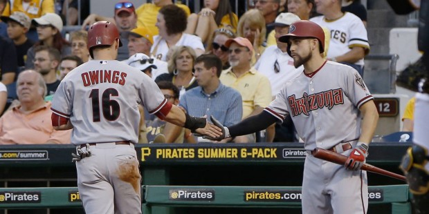 Arizona Diamondbacks' Chris Owings, left,  is greeted by on-deck batter Ender Inciarte, right,  aft...