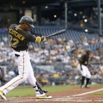 Pittsburgh Pirates' Andrew McCutchen (22) hits to Arizona Diamondbacks left fielder David Peralta to drive in Gregory Polanco from third with a sacrifice in the first inning of a baseball game, Tuesday, Aug. 18, 2015, in Pittsburgh. (AP Photo/Keith Srakocic)