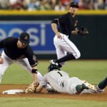 Arizona Diamondbacks second baseman Aaron Hill tags out Oakland Athletics  Billy Burns (1) trying to steal second base in the third inning during a baseball game, Saturday, Aug. 29, 2015, in Phoenix. (AP Photo/Rick Scuteri)