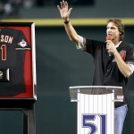 Hall of Fame pitcher Randy Johnson waves to the crowd during a ceremony retiring his No. 51 Diamondbacks jersey, before a baseball game between the Cincinnati Reds and the Diamondbacks, Saturday, Aug. 8, 2015, in Phoenix. (AP Photo/Ralph Freso)