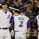 Arizona Diamondbacks' Paul Goldschmidt, left, shouts in celebration at Aaron Hill (2) and Welington Castillo (7) after both scored against the St. Louis Cardinals during the second inning of a baseball game Wednesday, Aug. 27, 2015, in Phoenix. (AP Photo/Ross D. Franklin)