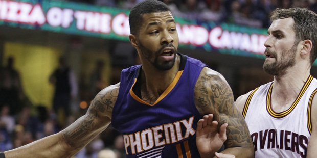 Phoenix Suns' Markieff Morris, left, drives past Cleveland Cavaliers' Kevin Love during the third q...