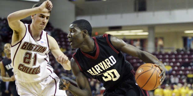 Harvard's Kyle Casey (30) drives against Boston College's Tyler Roche during the first half of an N...