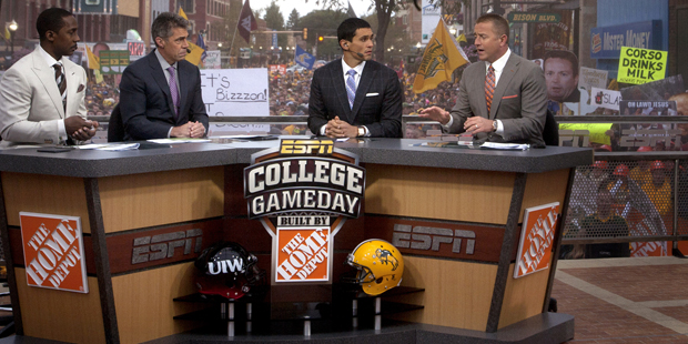 FILE - In this Sept. 13, 2014, file photo, Desmond Howard, Chris Fowler, David Pollack, and Kirk He...