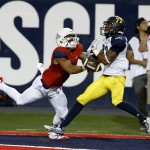 Arizona wide receiver Nate Phillips and Northern Arizona cornerback Marcus Alford (22) compete for the ball during the first half of an NCAA college football game, Saturday, Sept. 19, 2015, in Tucson, Ariz. (AP Photo/Rick Scuteri)