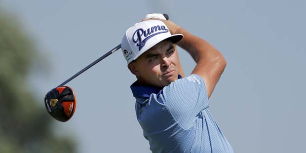 Rickie Fowler watches his tee shot on the 10th hole during the first round of the BMW Championship ...
