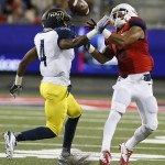 Arizona wide receiver Nate Phillips, right, makes the catch over Northern Arizona safety LeAndre Vaughn, left, during the second half of an NCAA college football game, Saturday, Sept. 19, 2015, in Tucson, Ariz. (AP Photo/Rick Scuteri)