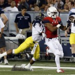 Northern Arizona safety Darius Lewis, left, knocks the ball away from Arizona wide receiver Nate Phillips during the first half of an NCAA college football game, Saturday, Sept. 19, 2015, in Tucson, Ariz. (AP Photo/Rick Scuteri)
