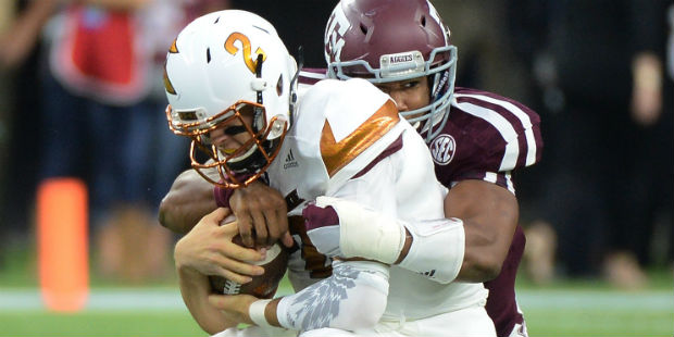 Arizona State quarterback Mike Bercovici (2) is wrapped up by Texas A&M defensive lineman Myles Gar...