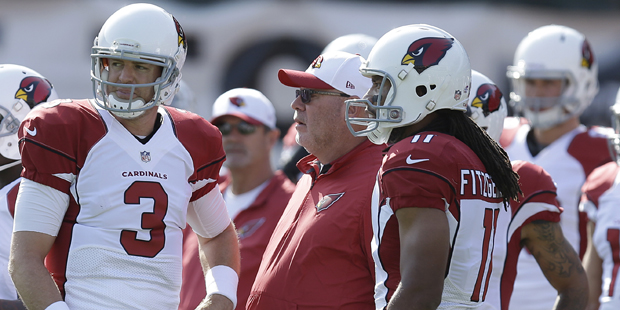 Arizona Cardinals quarterback Carson Palmer (3) talks with wide receiver Larry Fitzgerald (11) and ...