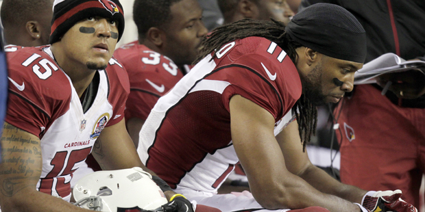 Arizona Cardinals wide receiver Larry Fitzgerald (11) and wide receiver Michael Floyd (15) sit on t...