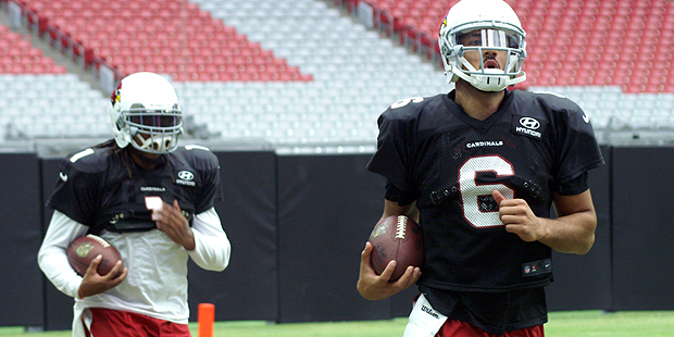 QBs Logan Thomas 6) and Phillip Sims 1) warm up prior to a training camp practice. Photo by: Adam G...