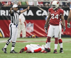 Buffalo Bills quarterback Trent Edwards lies on the ground after suffering a concussion against the Arizona Cardinals during the first the quarter of an NFL football game Sunday, Oct. 5, 2008 in Glendale, Ariz. At right is Cardinals' Adrian Wilson. (AP Photo/Ross D. Franklin)