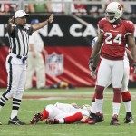 Buffalo Bills quarterback Trent Edwards lies on the ground after suffering a concussion against the Arizona Cardinals during the first the quarter of an NFL football game Sunday, Oct. 5, 2008 in Glendale, Ariz. At right is Cardinals' Adrian Wilson. (AP Photo/Ross D. Franklin)