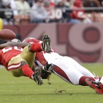 San Francisco 49ers running back Brian Westbrook (20) is hit by Arizona Cardinals safety Adrian Wilson (24) in the second quarter of an NFL football game in San Francisco, Sunday, Jan. 2, 2011. (AP Photo/Paul Sakuma)