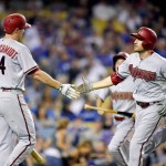 Arizona Diamondbacks' A.J. Pollock, right, is congratulated by Paul Goldschmidt after hitting a solo home run during the seventh inning of a baseball game against the Los Angeles Dodgers, Tuesday, Sept. 22, 2015, in Los Angeles. (AP Photo/Mark J. Terrill)