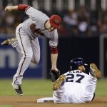Arizona Diamondbacks second baseman Phil Gosselin, left, misses the throw as San Diego Padres' Matt Kemp safely steals second base during the fourth inning of a baseball game Friday, Sept. 25, 2015, in San Diego. (AP Photo/Gregory Bull)