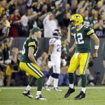 Green Bay Packers quarterback Aaron Rodgers (12) celebrates his touchdown pass to James Jones with teammate Scott Tolzien during the first half of an NFL football game against the Seattle Seahawks Sunday, Sept. 20, 2015, in Green Bay, Wis. (AP Photo/Jeffrey Phelps)