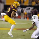 Arizona State's D.J. Foster (8) makes a catch in front of Cal Poly's Kevin Griffin (3) during the first half of an NCAA college football game Saturday, Sept. 12, 2015, in Tempe, Ariz. (AP Photo/Ross D. Franklin)