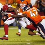 Arizona Cardinals running back Kerwynn Williams (33) scores a touchdown as Denver Broncos linebacker Zaire Anderson (47) defends during the second half of an NFL preseason football game, Thursday, Sept. 3, 2015, in Denver. (AP Photo/Jack Dempsey)