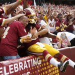 Washington Redskins running back Matt Jones jumps into the fans after scoring a touchdown during the first half of an NFL football game against the St. Louis Rams in Landover, Md., Sunday, Sept. 20, 2015. (AP Photo/Alex Brandon)