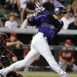 Colorado Rockies' Carlos Gonzalez hits a grand slam off Arizona Diamondbacks relief pitcher Keith Hessler during the seventh inning of a baseball game Wednesday, Sept. 2, 2015, in Denver. (AP Photo/Jack Dempsey)