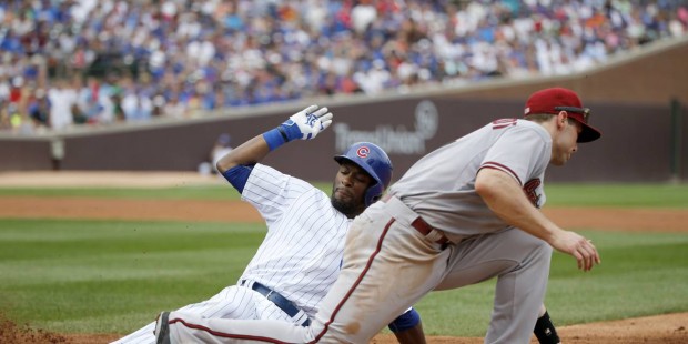 Chicago Cubs' Austin Jackson, left, is forced out at first on a throw from Arizona Diamondbacks rig...