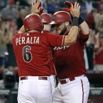 Arizona Diamondbacks' Jarrod Saltalamacchia, right, is congratulated by teammate David Peralta after hitting a 3-run home run against the Los Angeles Dodgers during the ninth inning of a baseball game, Sunday, Sept. 13, 2015, in Phoenix. The Dodgers defeated the Diamondbacks 4-3. (AP Photo/Ralph Freso)