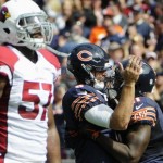 Chicago Bears quarterback Jay Cutler, center, and wide receiver Josh Bellamy (11) celebrate a touchdown as Arizona Cardinals linebacker Alex Okafor (57) walks off during the first half of an NFL football game, Sunday, Sept. 20, 2015, in Chicago. (AP Photo/David Banks)