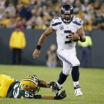 Seattle Seahawks' Russell Wilson runs past Green Bay Packers' Nick Perry during the second half of an NFL football game Sunday, Sept. 20, 2015, in Green Bay, Wis. (AP Photo/Mike Roemer)